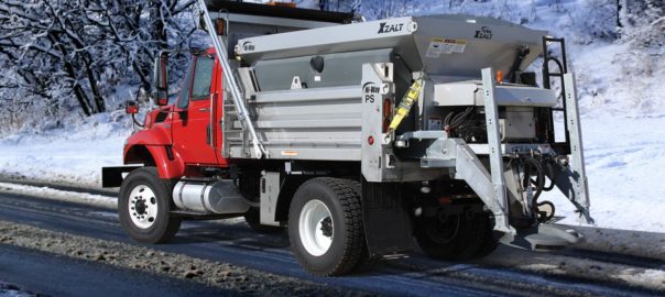 Xzalt Salt Spreader on a municipal truck driving on a slushy road